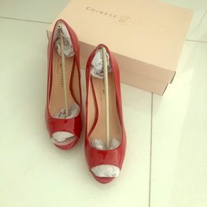 Peep toe red patented leather pumps